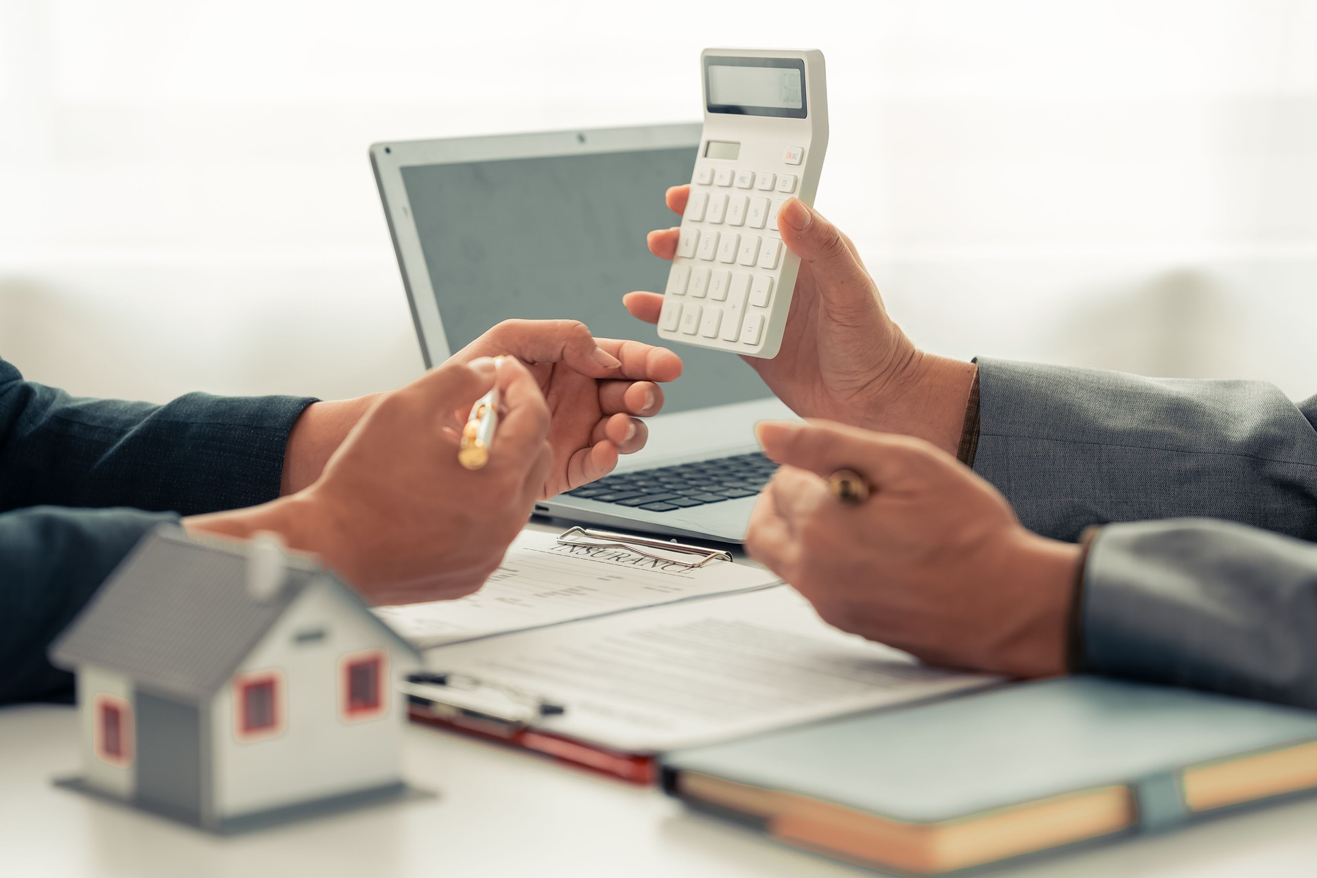 The real estate agent discussed the terms of the home purchase contract and asked the client to sign the document to legally complete the contract.